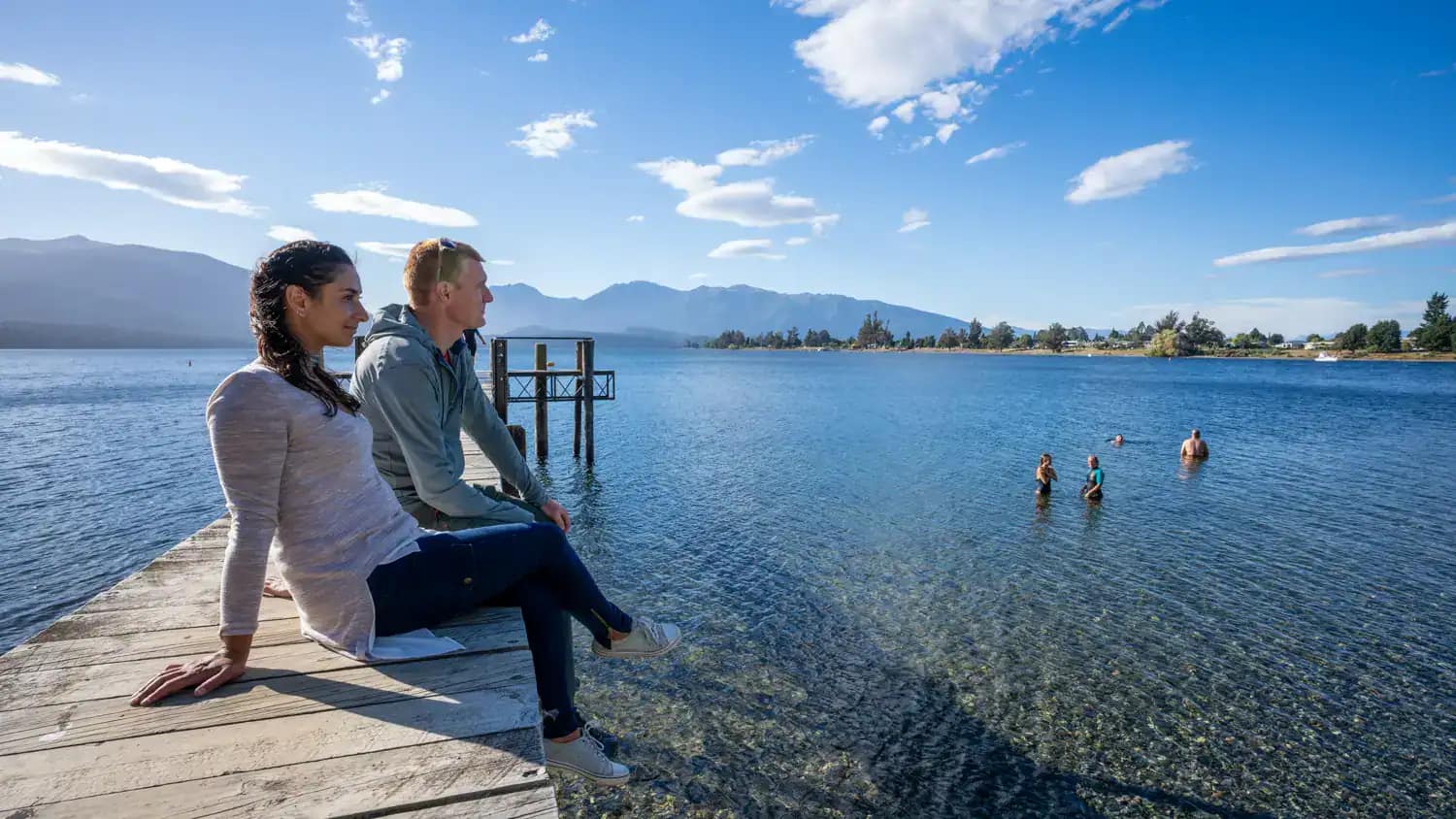 Free-things-to-do-in-te-anau-23 | Must Do New Zealand | Must Do New Zealand Yoiung tourist Couple taking int views over the lake from the wharf