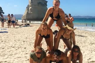 Group of young people on beach at Cathedral Cove, Coromandel | Must Do New Zealand Group of young people on beach at Cathedral Cove, Coromandel